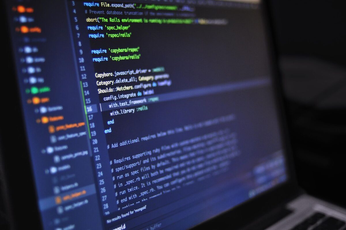 Ekran laptopa z kodem i wynikami testów — komunikat o brakującej bibliotece DLL